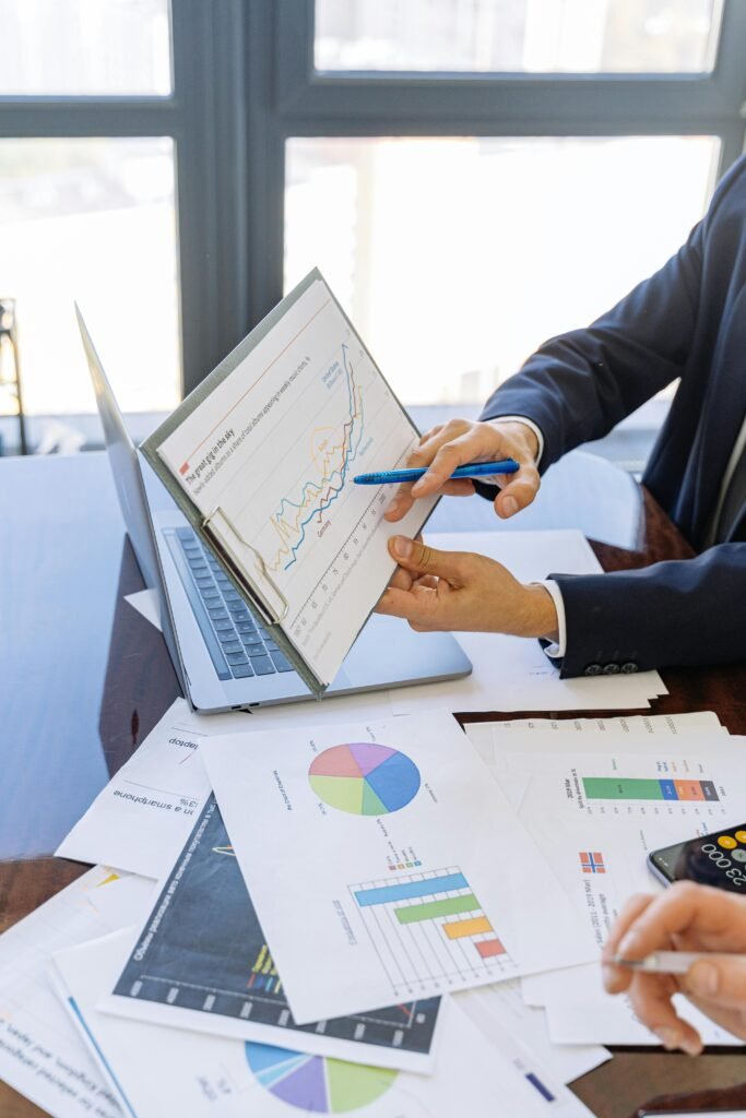 pexels-photo-5816299-5816299-2 Business professionals discussing financial graphs and charts in an office setting.